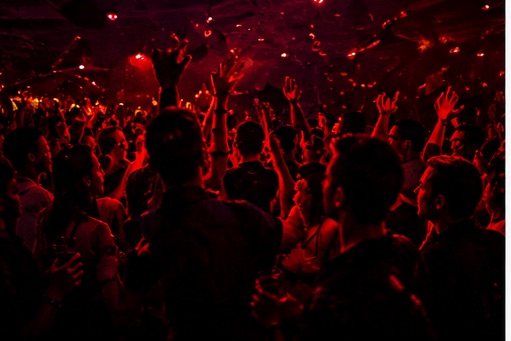 Packed dance floor under red light
