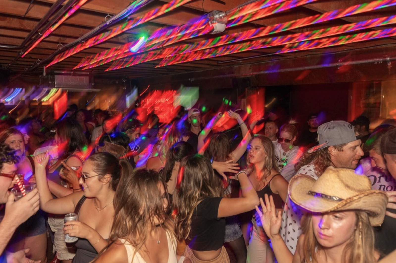 Birthday crowd dancing under disco lighting