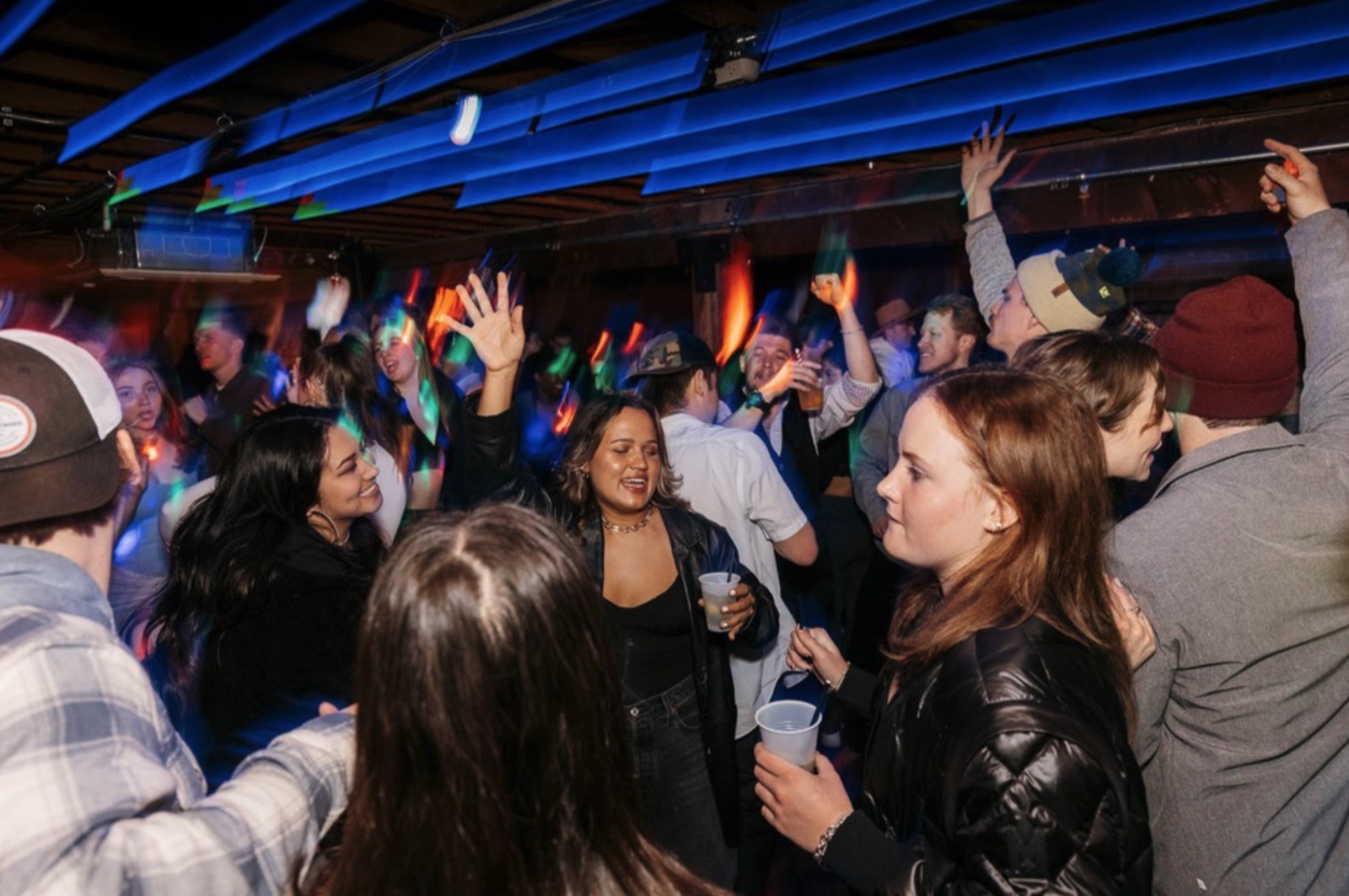 Crowd celebrating on the dance floor at The Spotted James in Boulder