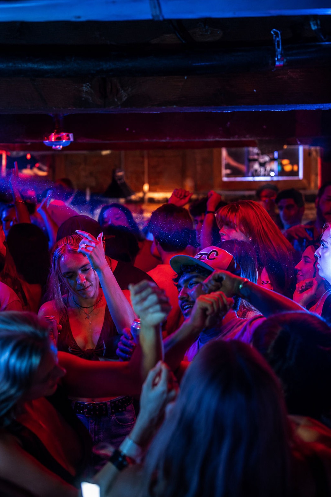 Dance floor packed under red and blue lighting