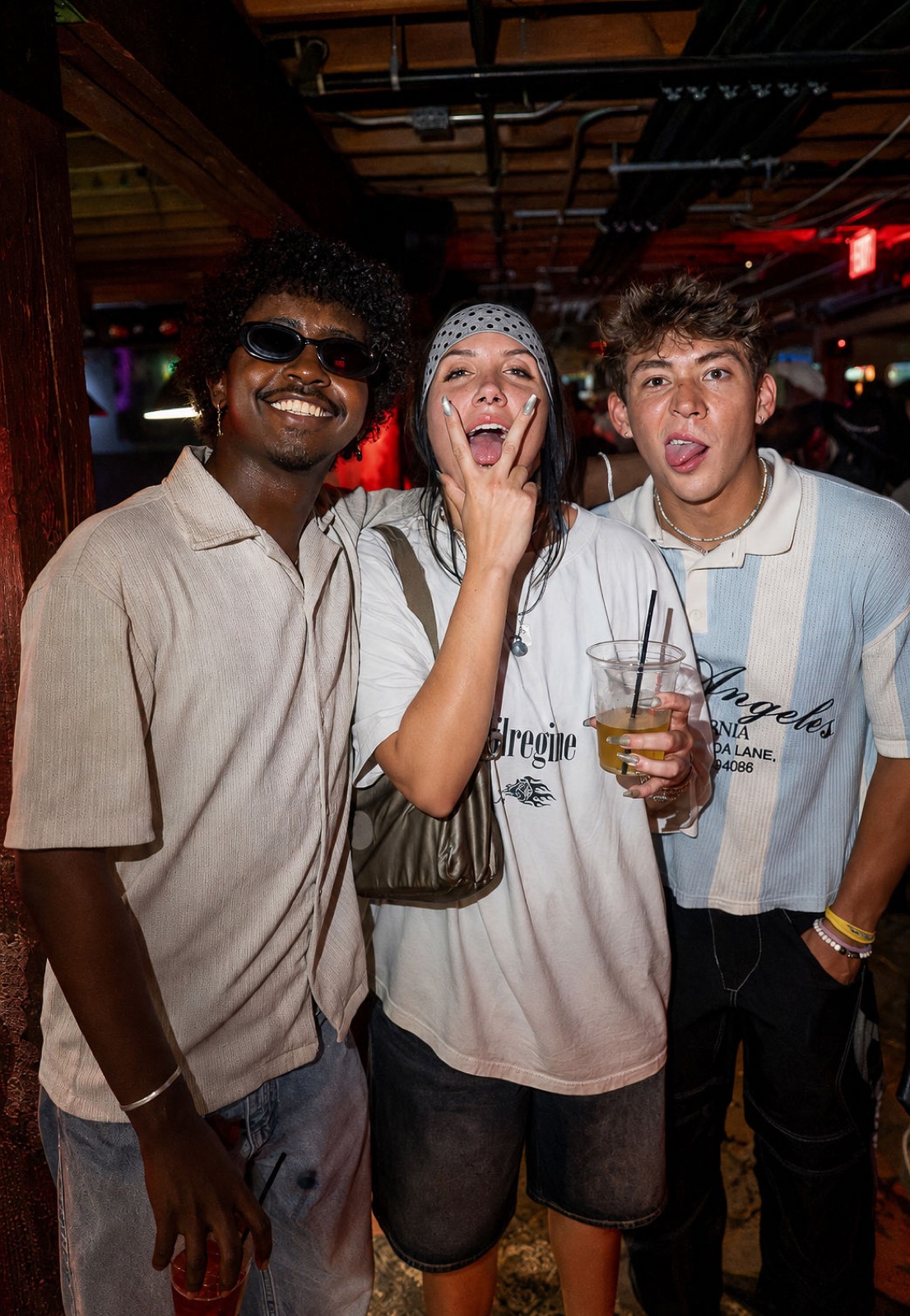 Friends posing with drinks at The Spotted James