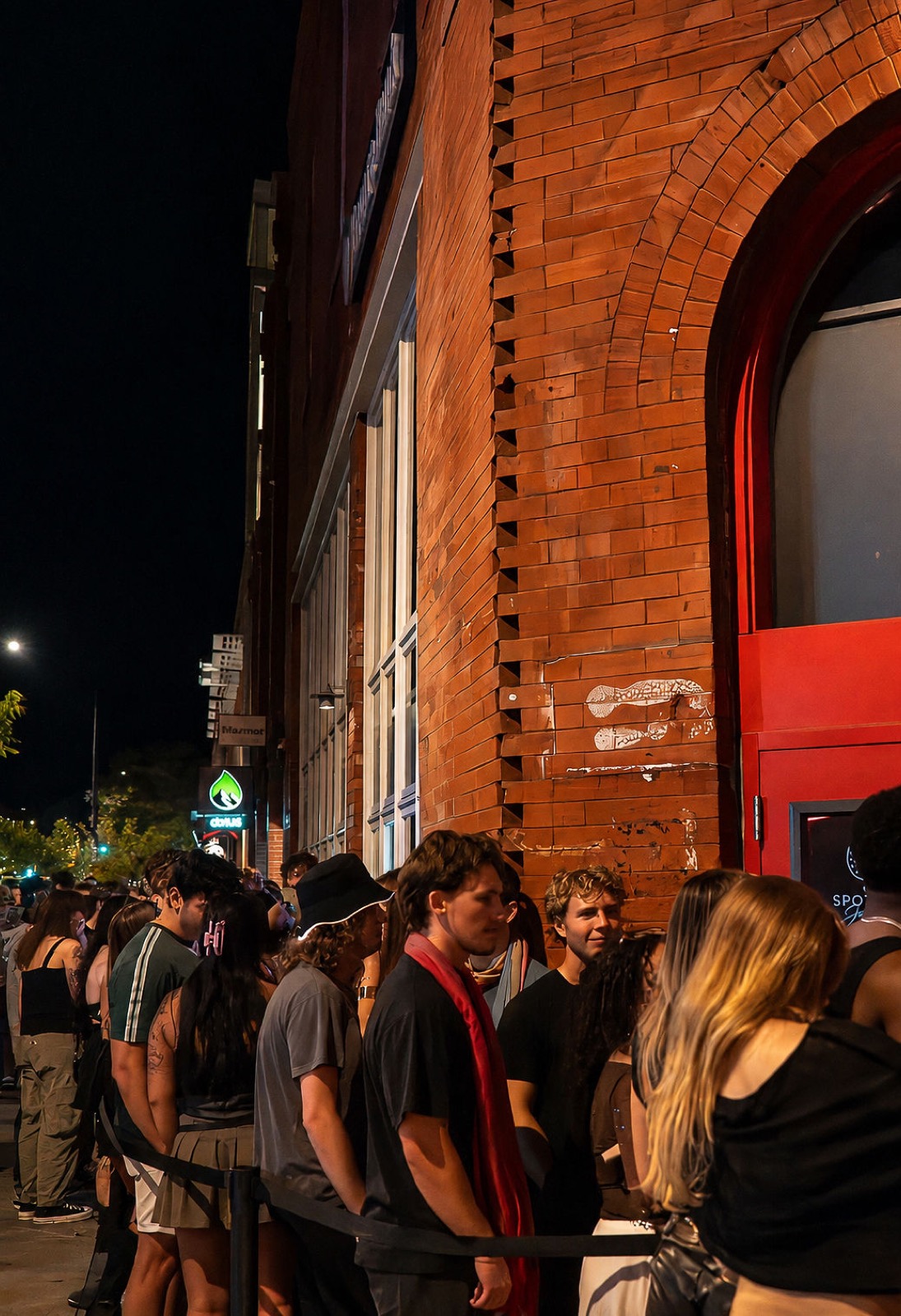 Guests waiting in line along the brick exterior of The Spotted James